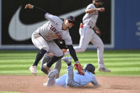 Toronto Blue Jays' Santiago Espinal (5) is tagged out by Cleveland Guardians second baseman Andres Gimenez on an attempted steal during the fifth inning of a baseball game in Toronto on Saturday, Aug. 13, 2022. (Jon Blacker/The Canadian Press via AP)