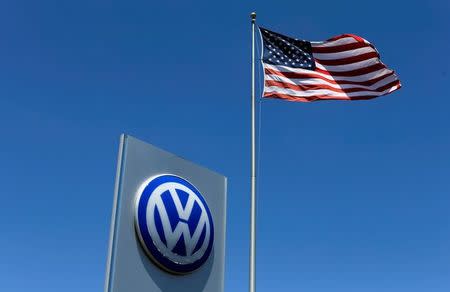 FILE PHOTO - A U.S. flag flutters in the wind above a Volkswagen dealership in Carlsbad, California, U.S. May 2, 2016. REUTERS/Mike Blake/File Photo