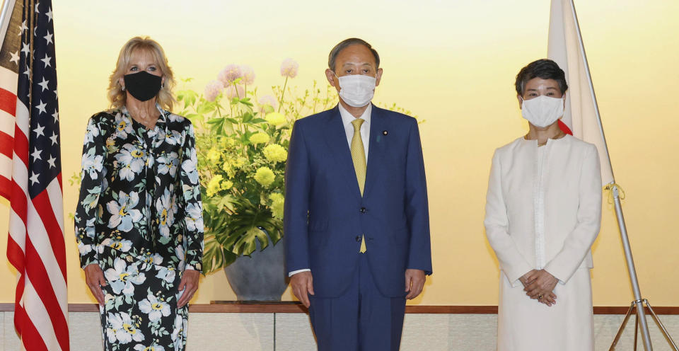 First lady of the U.S. Jill Biden poses for a photo with Japanese Prime Minister Yoshihide Suga and his wife Mariko in Tokyo, Thursday, July 22, 2021. Biden embarked on her first solo international trip as first lady, leading a U.S. delegation to the Olympic Games in Tokyo, where the coronavirus is surging and COVID-19 infections have climbed to a six-month high. (Kyodo News via AP)