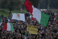 FILE - A demonstrator holds a banner reading "No Green Pass, Freedom" during a protest against restrictions for the unvaccinated at Rome Circus Maximus, Saturday, Nov. 20, 2021. The coronavirus's omicron variant kept a jittery world off-kilter Wednesday Dec. 1, 2021, as reports of infections linked to the mutant strain cropped up in more parts of the globe, and one official said that the wait for more information on its dangers felt like “an eternity.” (AP Photo/Alessandra Tarantino, File)