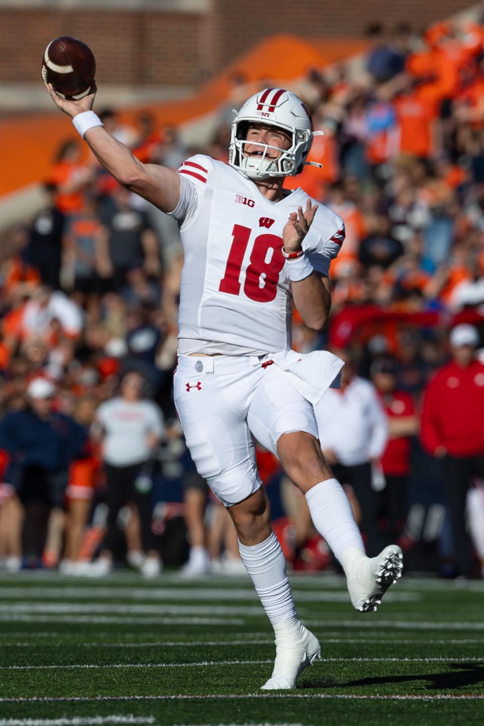 CHAMPAIGN, ILLINOIS - OCTOBER 21: Braedyn Locke #18 of the Wisconsin Badgers throws the ball during the first half against the Illinois Fighting Illini at Memorial Stadium on October 21, 2023 in Champaign, Illinois. (Photo by Michael Hickey/Getty Images)