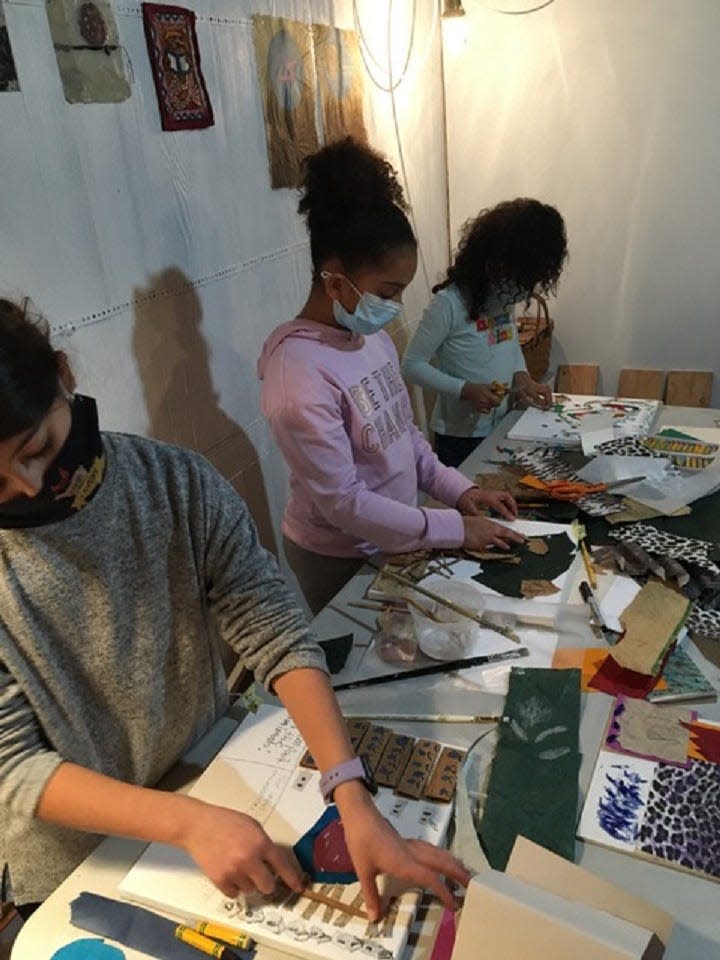 From left, Dani Chianciola, 10 of Eastham, Eva Edwards, 11, of Truro, and sister Lulu Edwards, 9, of Truro, create art themed to the beliefs of the Rev. Dr. Martin Luther King Jr. for a youth art show in Wellfleet.