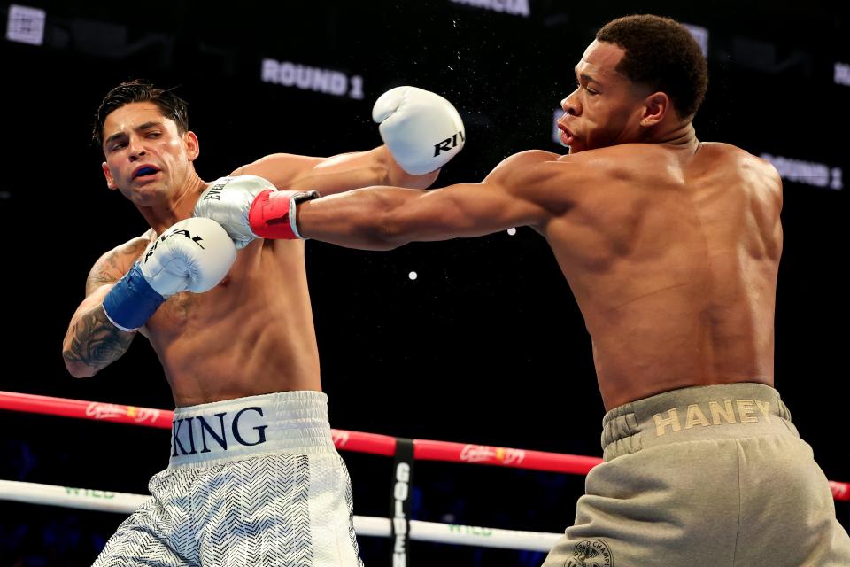 Ryan Garcia and Devin Haney throw punches during their April 20 fight.