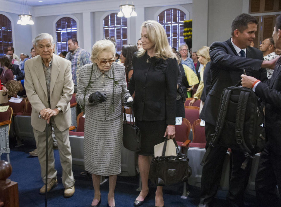 FILE - Former Hawaii Gov. George Ariyoshi, left, and Princess Abigail Kawananakoa, center, arrive before oral arguments at the Hawaii State Supreme Court in Honolulu, Aug. 27, 2015. There will be at least $100 million leftover to fund Native Hawaiian causes from the estate of the so-called last Hawaiian princess who died last year at age 96. According to court documents filed last week in the probate case for the estate of Abigail Kawānanakoa, $40 million will go to her wife. (Craig T. Kojima/Honolulu Star-Advertiser via AP, Pool, File)