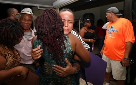 Families react as they are reunited after a church group was evacuated from the Abaco Islands after Hurricane Dorian made landfall in Nassau