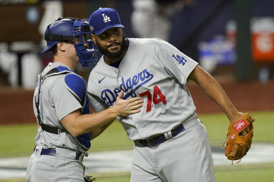 Los Angeles Dodgers relief pitcher Kenley Jansen and catcher Will Smith celebrate their win against the Atlanta Braves in Game 5 of a baseball National League Championship Series Friday, Oct. 16, 2020, in Arlington, Texas. (AP Photo/Eric Gay)