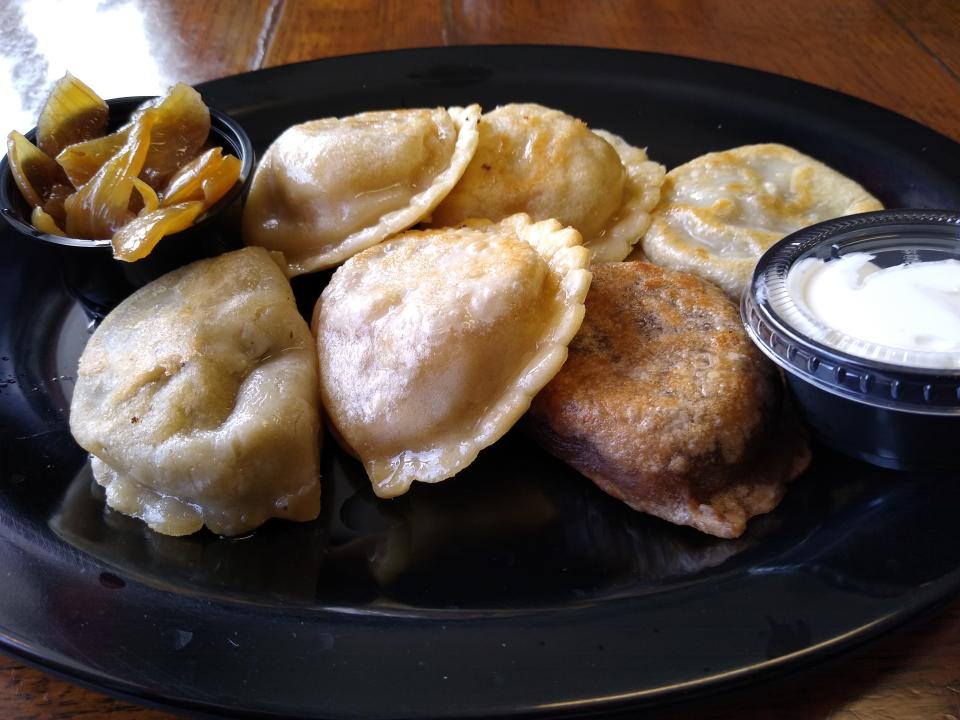 Pierogies of Cleveland offers 36 flavors of pierogies. Here are six of them, served with caramelized onions and sour cream in Richfield. Half of the fun is trying to figure out which one is which.