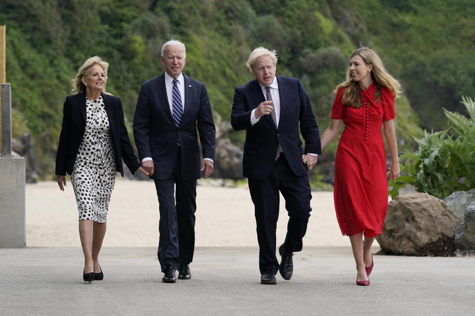 President Joe Biden and first lady Jill Biden are greeted and walk with British Prime Minister Boris Johnson and his wife Carrie Johnson, ahead of the G-7 summit, Thursday, June 10, 2021, in Carbis Bay, England. (AP Photo/Patrick Semansky)