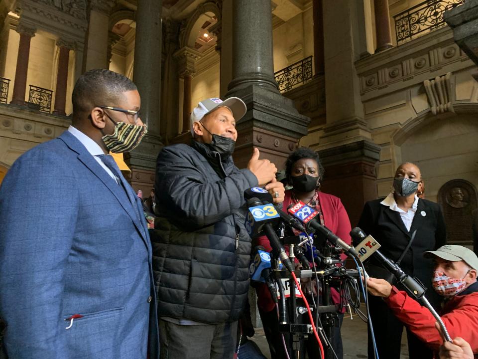 Walter Wallace Sr. speaks during a Thursday afternoon press conference outside Philadelphia's City Hall. Shaka Johnson, left, is representing the family.