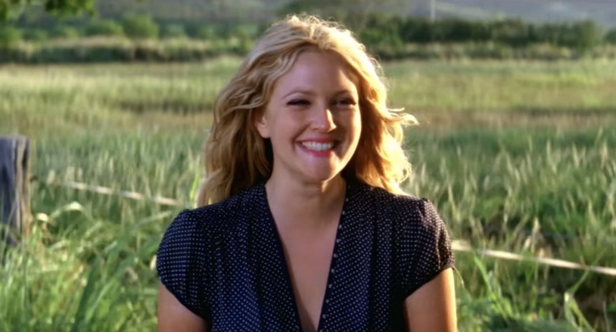 a woman smiling in a field