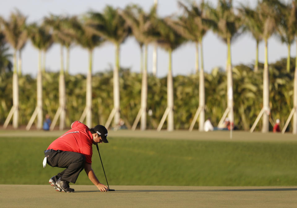 Patrick Reed sets up his final putt before winning the Cadillac Championship golf tournament Sunday, March 9, 2014, in Doral, Fla. (AP Photo/Wilfredo Lee)