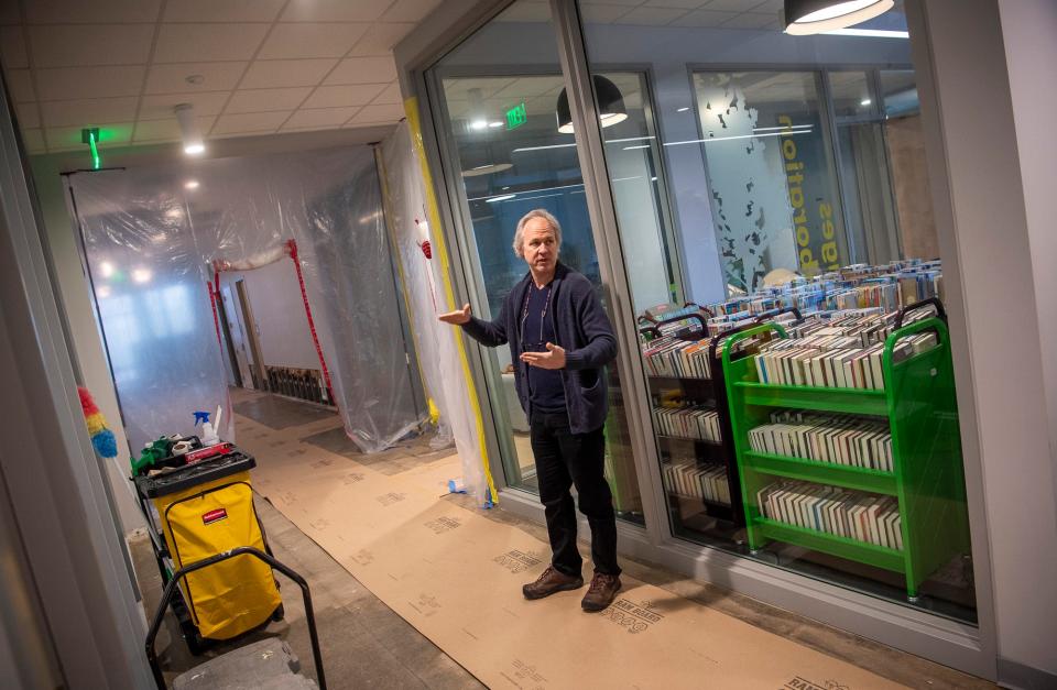 Monroe County Public Library Director Grier Carson points out the damage caused by flooding. Carson said part of the HVAC system malfunctioned, leading to burst pipes and 3 to 4 inches of water on the floor.