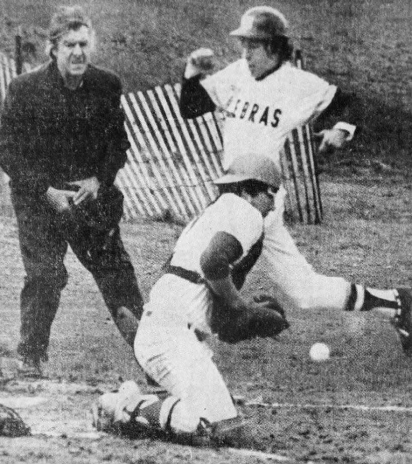 New Brunswick High School’s John Puccio speeds past Edison catcher Bob Mirabelle to score a run in the second inning of Monday, April 15, 1974’s game. Plate umpire Ed Sinicki watches the play, which climaxed a successful delayed double steal for the Zebras. New Brunswick won 6-4.