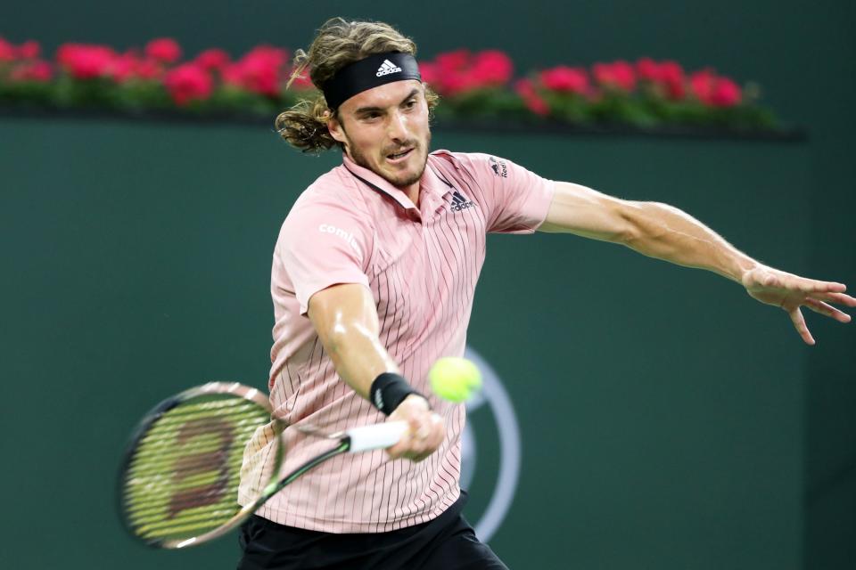 Stefanos Tsitsipas of Greece returns a shot to American Jenson Brooksby during the BNP Paribas Open in Indian Wells, Calif., on Monday, March 14, 2022.