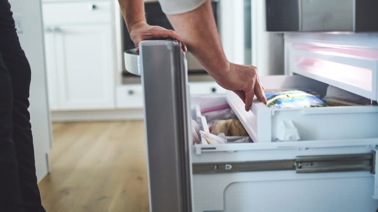 Person opening freeze drawer