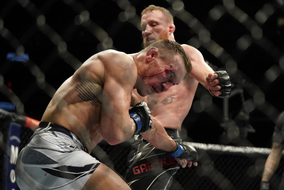 Michael Chandler, left, exchanges punches with Justin Gaethje during a lightweight mixed martial arts bout at UFC 268, Saturday, Nov. 6, 2021, in New York. (AP Photo/Corey Sipkin)