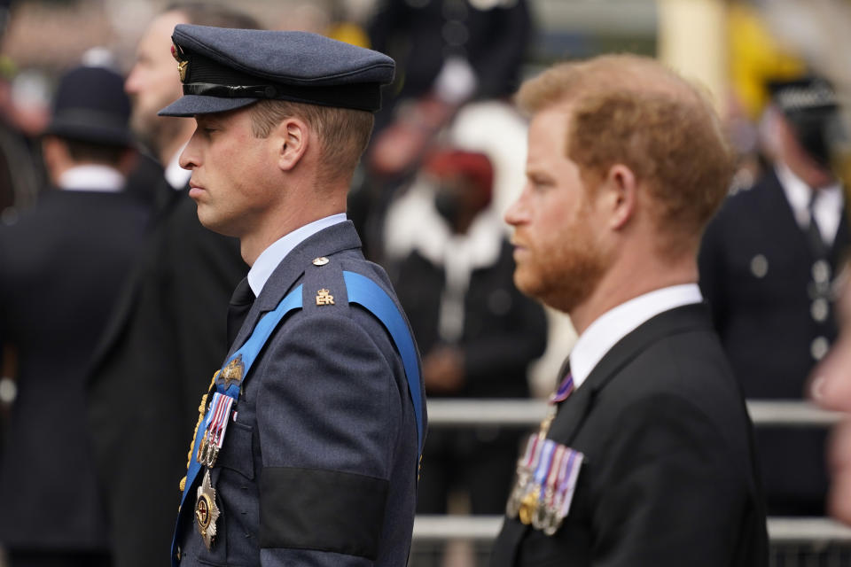 FILE - Prince William, center, and Prince Harry, right, walk behind the coffin of Queen Elizabeth II being pulled past Buckingham Palace following her funeral service at Westminster Abbey in central London, on Sept. 19, 2022. An explosive memoir reveals many facets of Prince Harry, from bereaved boy and troubled teen to wartime soldier and unhappy royal. From accounts of cocaine use and losing his virginity to raw family rifts, “Spare” exposes deeply personal details about Harry and the wider royal family. It is dominated by Harry's rivalry with brother Prince William and the death of the boys’ mother, Princess Diana in 1997. (AP Photo/Alberto Pezzali, File)