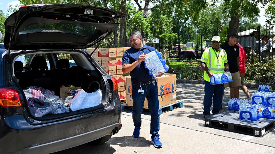 Volunteers hand out water at a distribution station in Houston, Texas, on Wednesday. - Maria Lysaker/AP