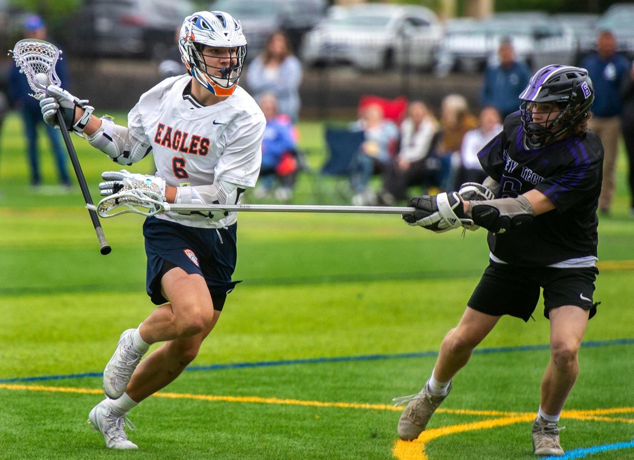 Advanced Math & Science Academy Charter School  (AMSA) lacrosse junior Luc Masse, of Hudson, left, defended by  Blackstone Valley Technical School (BVT) sophomnore Chris Bouvier in a Round of 32 playoff game, June 5, 2023, at the Forekicks Sports Complex in Marlborough.