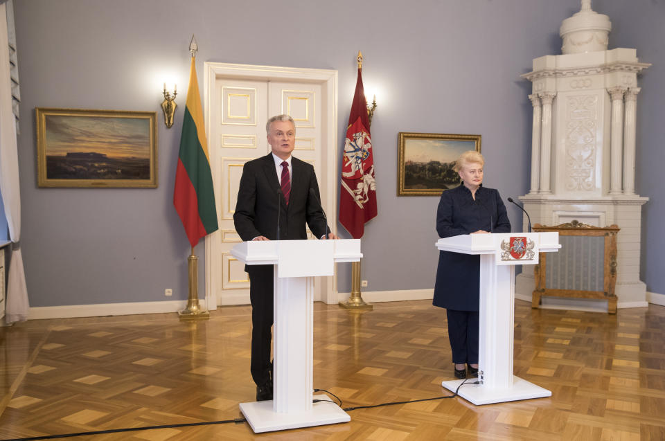 Lithuanian President-elect Gitanas Nauseda, left, speaks during a joint press conference with Lithuania's President Dalia Grybauskaite, at the President's palace in Vilnius, Lithuania, Monday, May 27, 2019. (AP Photo/Mindaugas Kulbis)