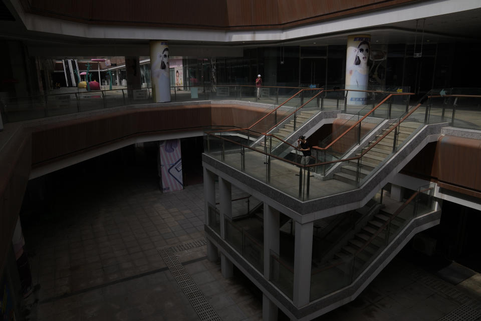 Residents walk by a deserted Evergrande city plaza in Beijing on Sept. 18, 2023. China's leaders are expected to search for ways to mend the country's fractured property market, create jobs for millions of unemployed youths and spur faster growth in a meeting that reportedly began Monday, Oct. 30 in Beijing. (AP Photo/Andy Wong)