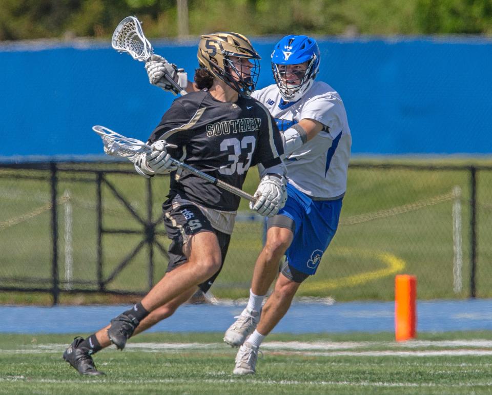 Southern Joey DeYoung tries to advance on goals against Shore Regional Zac Mansfield. Shore Regional Boys Lacrosse vs. Shore Regional in West Long Branch on may 15, 2021.
