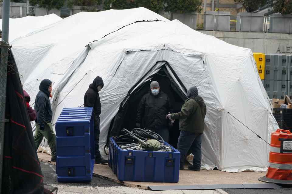 Workers construct what is believed to be a makeshift morgue behind a hospital during the outbreak of coronavirus disease (COVID-19), in the Manhattan borough of New York City