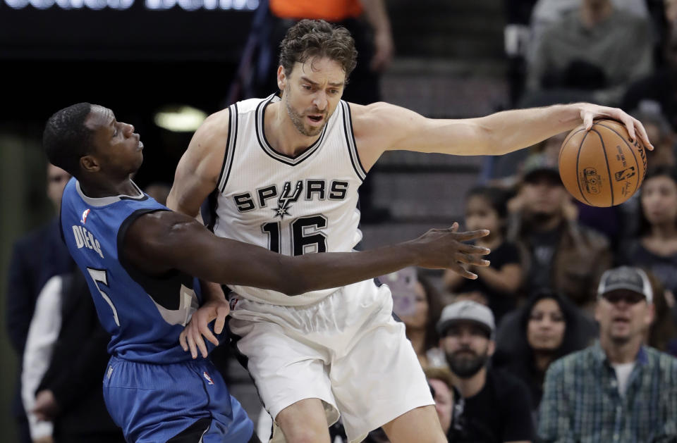 San Antonio Spurs center Pau Gasol (16) is pressured by Minnesota Timberwolves forward Gorgui Dieng (5) during the first half of an NBA basketball game, Tuesday, Jan. 17, 2017, in San Antonio. (AP Photo/Eric Gay)