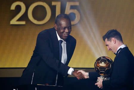FIFA acting president Issa Hayatou (L) congratulates FC Barcelona's Lionel Messi of Argentina with winning the FIFA Ballon d'Or 2015 award for the world player of the year at a ceremony in Zurich, Switzerland, January 11, 2016. REUTERS/Ruben Sprich