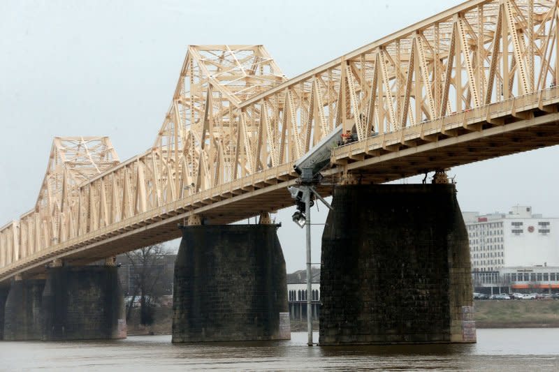 Louisville Metro fire and emergency crews rescued the driver of a semi-truck dangling over the Clark Memorial Bridge Friday. Louisville Fire Chief Brian O'Neill said the driver was "extremely lucky" the truck didn't fall off the bridge. Photo by John Sommers II/UPI