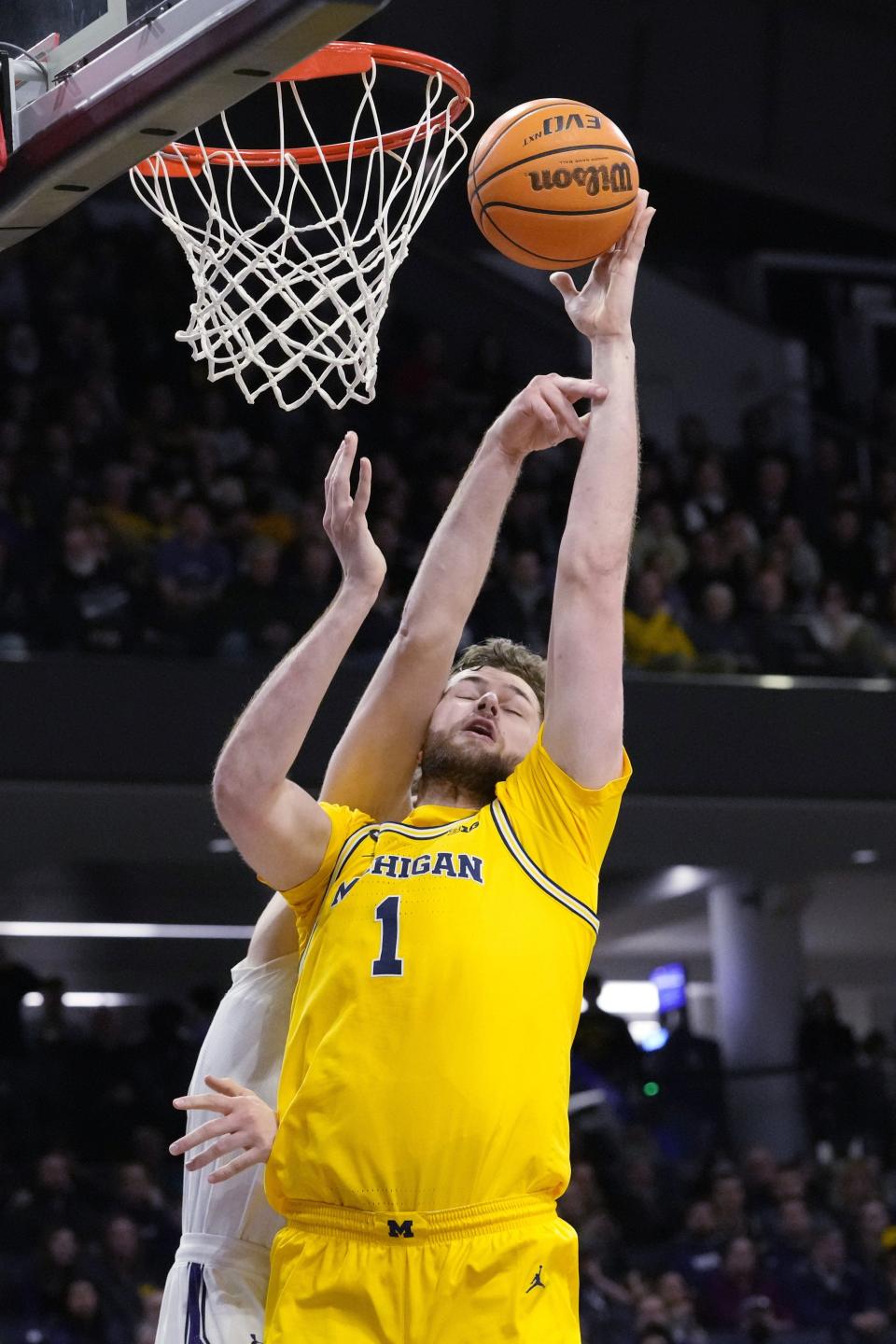 Michigan center Hunter Dickinson, right, shoots against Northwestern center Matthew Nicholson during the first half on Thursday, Feb. 2, 2023, in Evanston, Illinois.