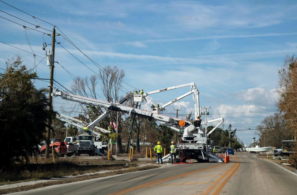 Oct 3, 2022; Fort Myers, FL, USA; Crews work on power lines on John Morris Boulevard on Monday, Oct. 3, 2022, in Fort Myers.  Mandatory Credit: Amanda Inscore-USA TODAY NETWORK ORIG FILE ID:  20221004_ajw_usa_029.JPG