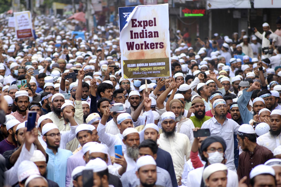 Muslims hold placards and shout slogans against Nupur Sharma, a spokesperson of India's governing Hindu nationalist party as they react to the derogatory references to Islam and the Prophet Muhammad made by her, during a protest outside a mosque in Dhaka, Bangladesh, Friday, June 10, 2022. Thousands of people marched in Bangladesh's capital on Friday to urge Muslim-majority nations to cut off diplomatic ties with India and boycott its products unless it punishes two governing party officials for comments deemed derogatory to Islam's Prophet Muhammad. (AP Photo/Mahmud Hossain Opu)