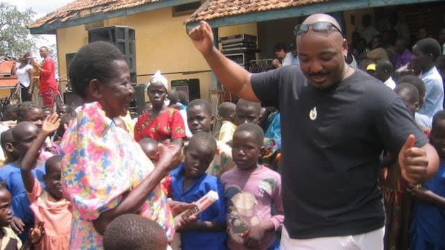 Darrell Blocker dances with locals during a 2004 undercover assignment in Uganda (Courtesy of Spyex)