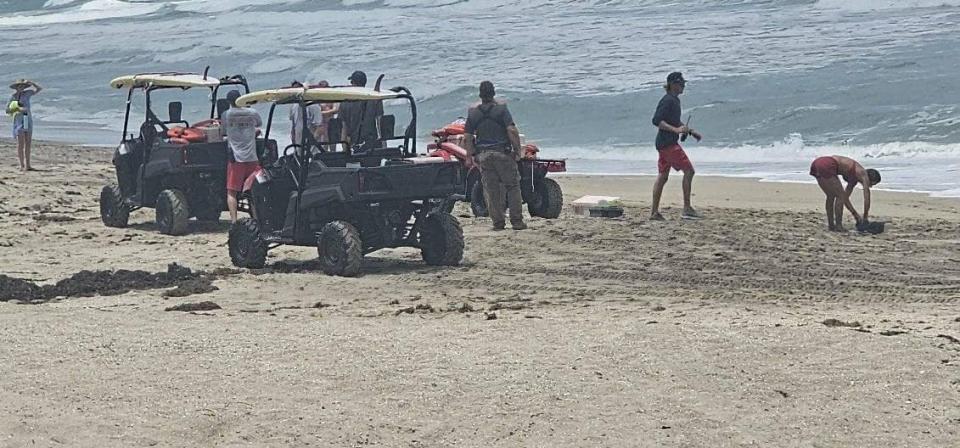 Martin County Ocean Rescue lifeguards and Martin County Sheriff's Office deputies at a Hutchinson Island area shoreline where a man and woman were pulled from a rip current and later declared dead in a local hospital Thursday, June 20, 2024.