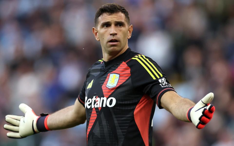 Emiliano Martinez gestures with his arms wide open while playing for Aston Villa