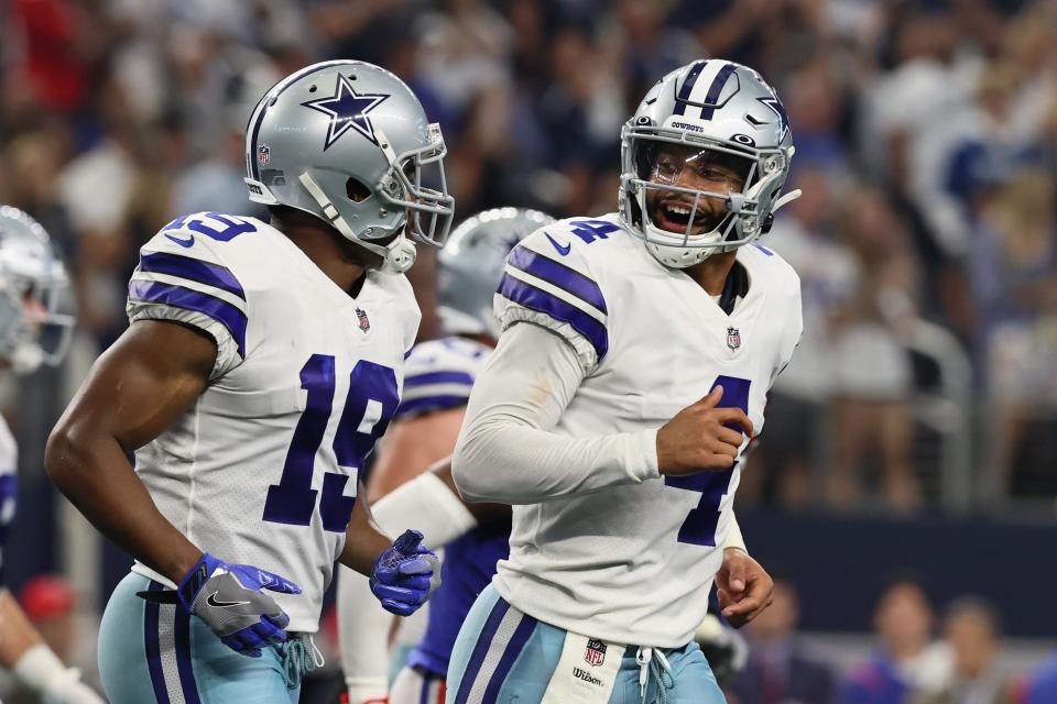 Dallas Cowboys quarterback Dak Prescott (4) celebrates with Dallas Cowboys wide receiver Amari Cooper (19) after a touchdown by Dallas Cowboys running back Ezekiel Elliott (not pictured) in the fourth quarter against the New York Giants at AT&T Stadium.