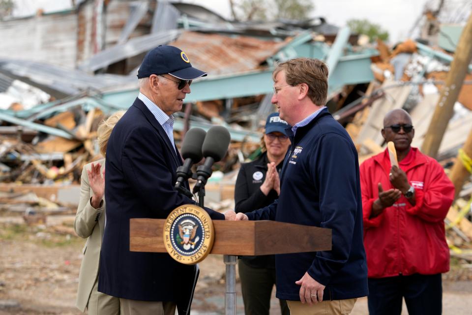 FILE - President Joe Biden shakes hands with Mississippi Gov. Tate Reeves after surveying tornado damage in Rolling Fork, Miss., March 31, 2023. Reeves, a Republican, faces Democrat Brandon Presley in the Nov. 7, general election and has been trying to appeal to conservative voters by connecting Presley to Biden. (AP Photo/Carolyn Kaster, File)