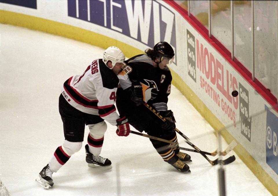 Jaromir Jagr of the Pittsburgh Penguins moves for the puck with Scott Stevens of the New Jersey Devils during a 1999 game at the then-Continental Airlines Arena.