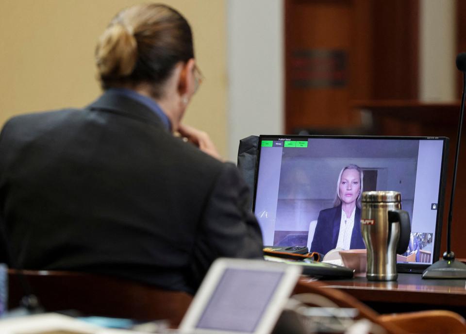 Johnny Depp listens as his former girlfriend, Model Kate Moss, testifies via video link at the Fairfax County Circuit Courthouse in Fairfax, Virginia, on May 25, 2022