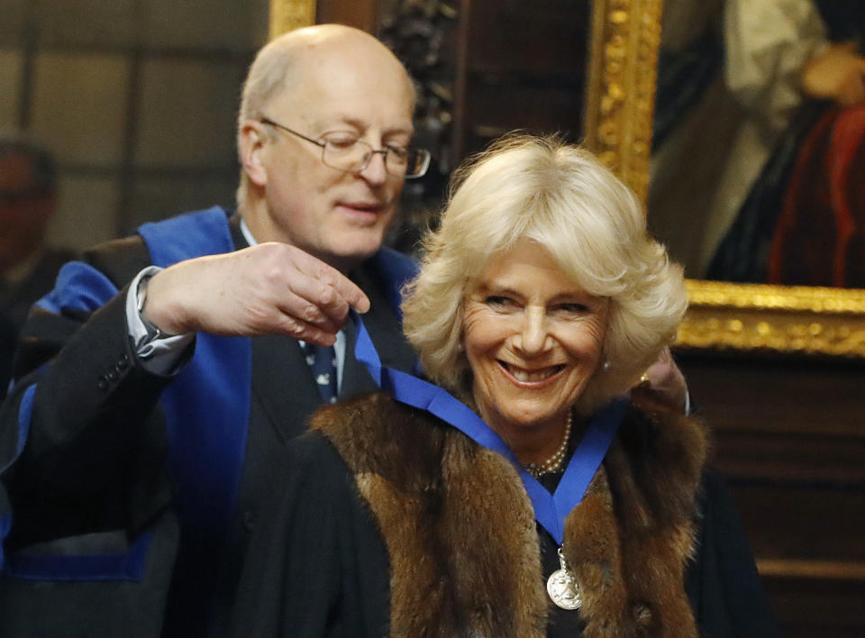 FILE - Britain's Camilla, The Duchess of Cornwall receives a medal from Brigadier Jonathan Bourne-May as she is installed as a Liveryman of The Worshipful Company of Vintners, in London, Wednesday, Jan. 25, 2017. Britain's queen consort, Camilla, has come a long way. On May 6, she will be crowned alongside her husband and officially take her first turns on the world stage as Queen Camilla. It’s been a remarkable and painstakingly slow transformation over five decades. (AP Photo/Frank Augstein, Pool, File)