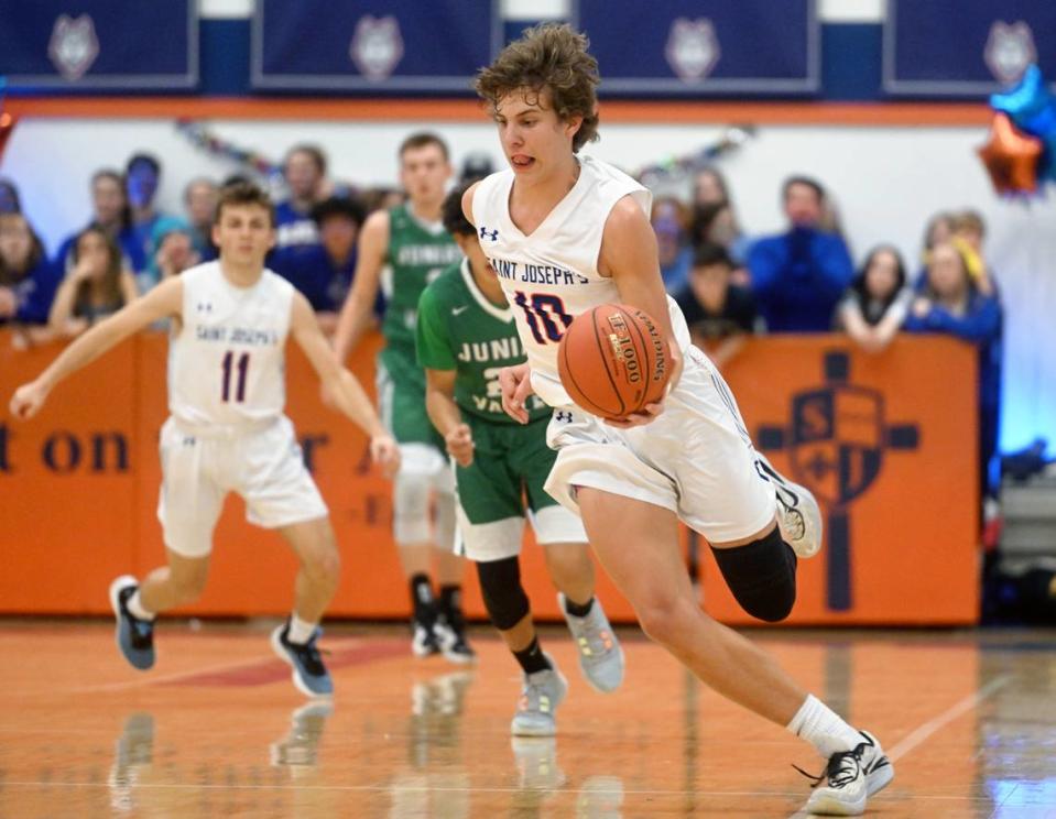 Saint Joseph’s Charlie Yartz dribbles down the court ahead of Juniata Valley defenders during the game on Wednesday, Feb. 1, 2023.