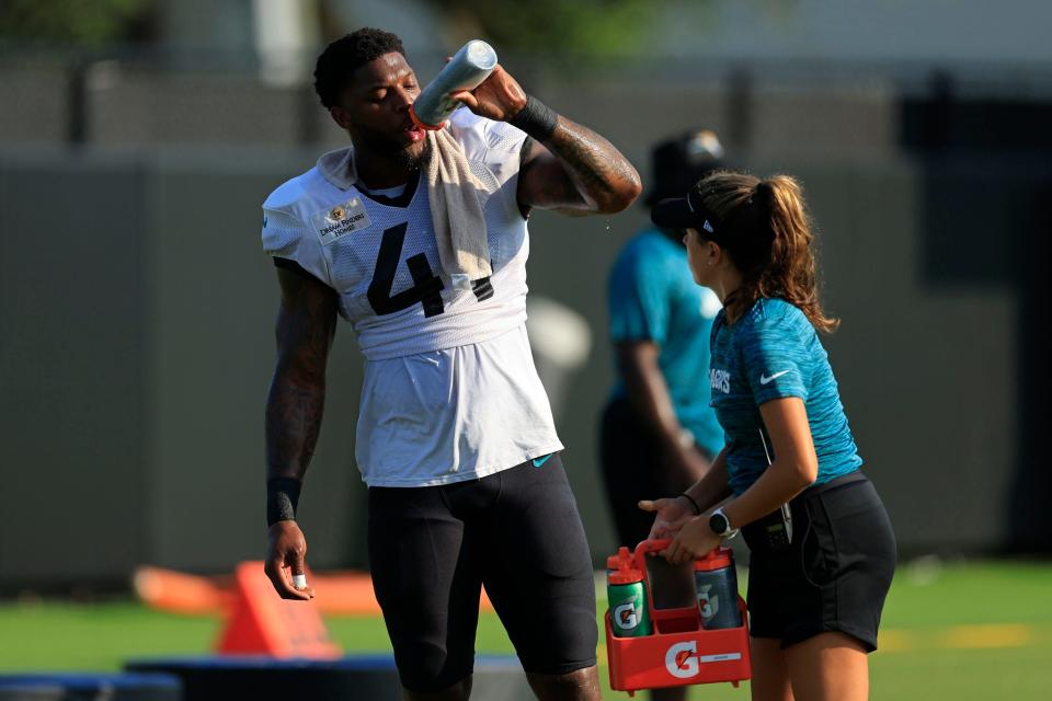 Jaguars linebacker Josh Allen (41) hydrates during the first padded practice of the 2023 preseason.