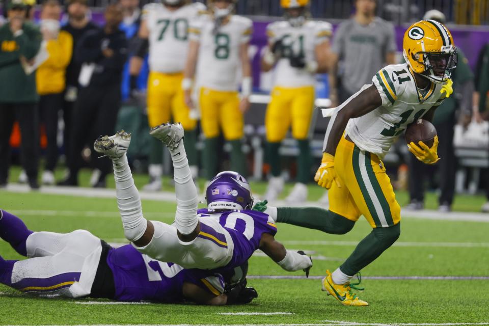 Green Bay Packers' Jayden Reed breaks away for a touchdown catch during the first half of an NFL football game against the Minnesota Vikings Sunday, Dec. 31, 2023, in Minneapolis. (AP Photo/Bruce Kluckhohn)