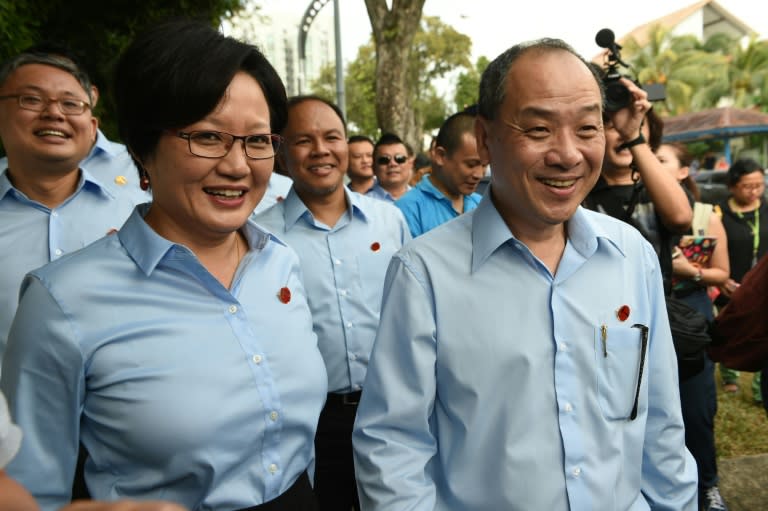 Leader of the opposition Worker's Party (WP) Low Thia Kang (R), with party chairperson Sylvia Lim and their team arrive at the nomination centre to file their documents, ahead of the general election in Singapore, on September 1, 2015