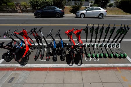 Scooters and bikes are shown legally parked in a designated scooter zone in San Diego, California