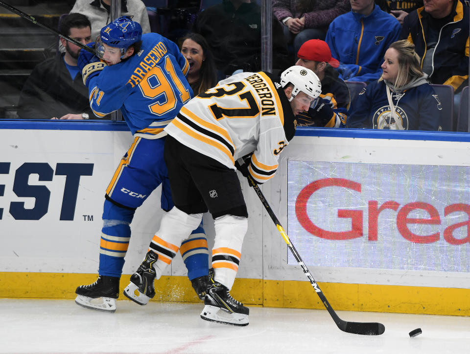 ST. LOUIS, MO- FEBRUARY 23: Boston Bruins center Patrice Bergeron (37) goes after a loose puck after checking St. Louis Blues rightwing Vladimir Tarasenko (91) during a NHL game between the Boston Bruins and the St. Louis Blues on February 23, 2019, at Enterprise Center, St. Louis, MO. (Photo by Keith Gillett/Icon Sportswire via Getty Images)