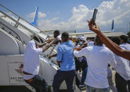 Haitians deported from the United States try to board the same plane in which they were deported, in an attempt to return to the United States, on the tarmac of the Toussaint Louverture airport in Port-au-Prince, Haiti Tuesday, Sept. 21, 2021. (AP Photo/Joseph Odelyn)