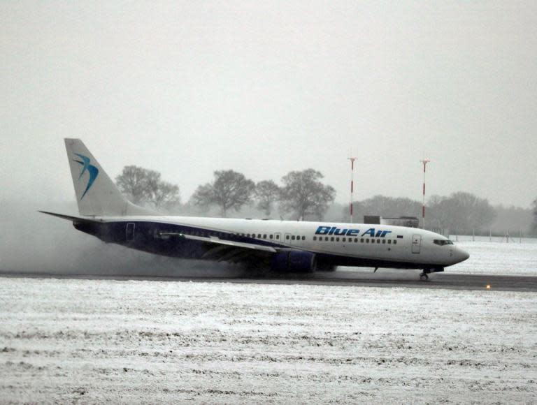 UK weather and travel - as it happened: Flight cancellations and lorry crashes cause misery as airports warn of more disruption