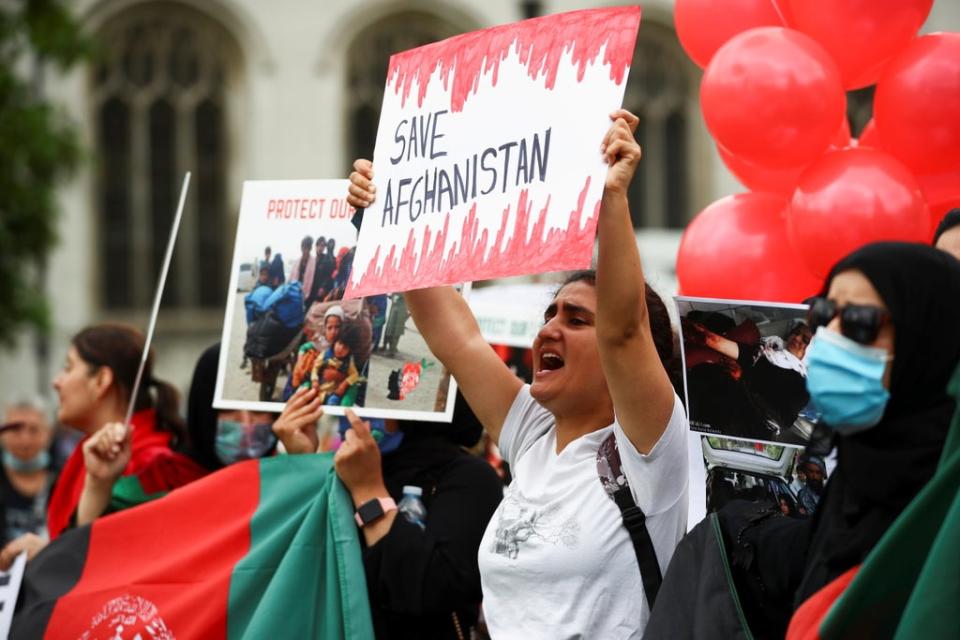 Demonstrators hold “save Afghanistan” banners in Parliament Square (REUTERS)